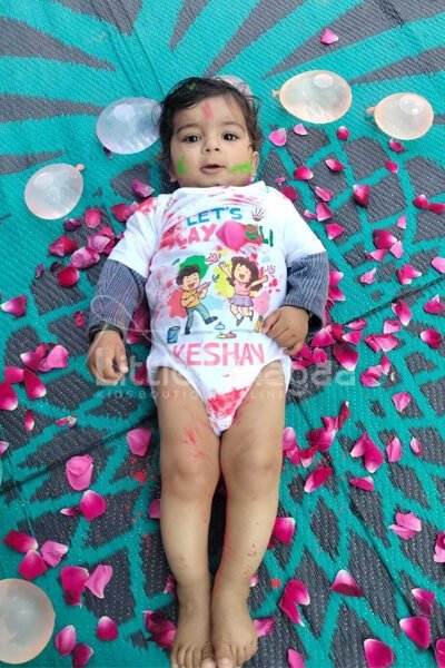 Baby enjoying first Holi in soft cotton colorful onesie