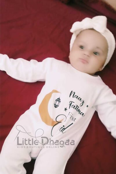 Baby wearing Eid jumpsuit smiling happy customer picture