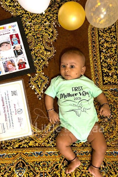 Cute baby in Mother’s Day outfit with positive customer review